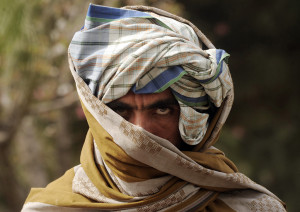 A former Taliban fighter looks on after