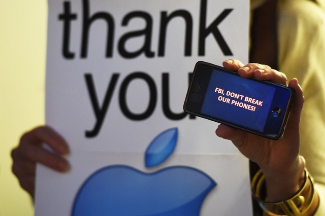 Protesters demonstrate outside an Apple Store as they object to the US government's attempt to put a backdoor to hack into the Apple iPhone. Mark Ralston / AFP Photo