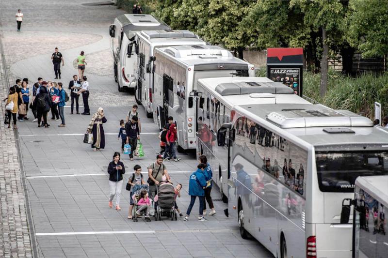 No end in sight. Migrants wait to board a bus during the evacuation of a makeshift camp in La Villette Park in Paris, August 28.